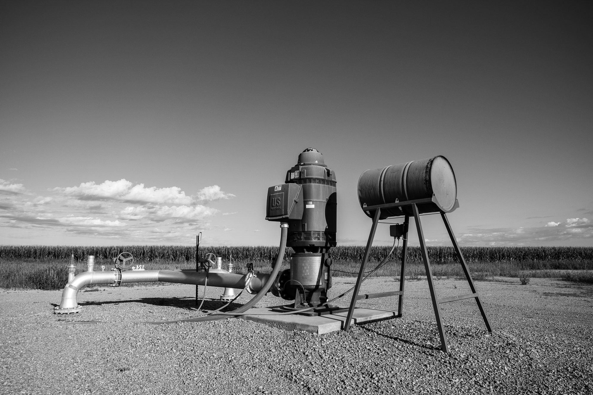 a barrel on sticks and a well in a dry patch of land